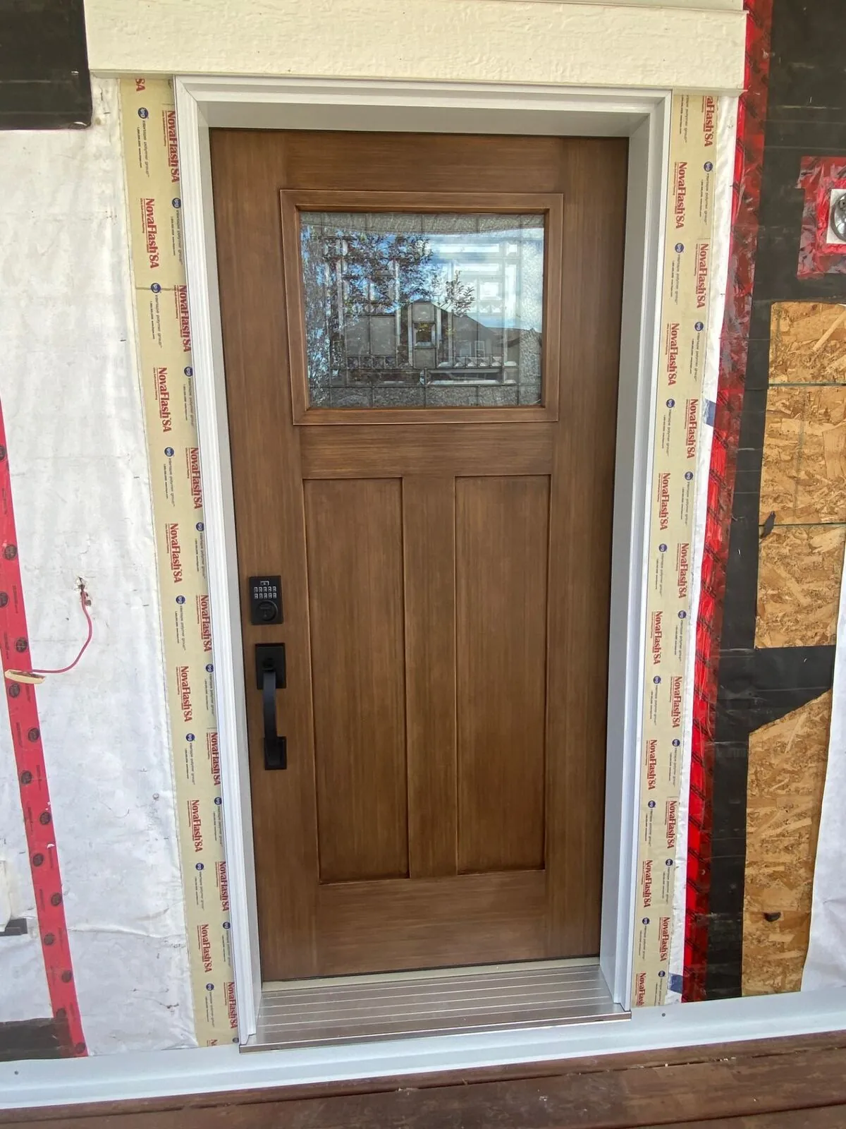 Craftsman walnut entry door with sidelites
