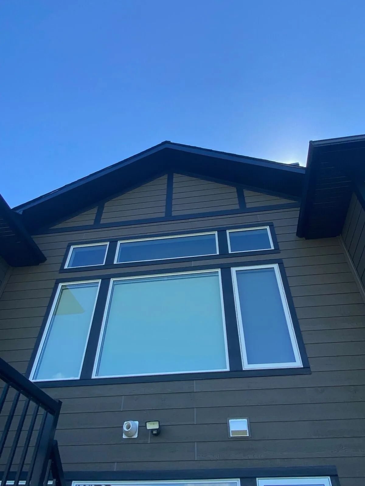 Craftsman home with brown siding and dark trim