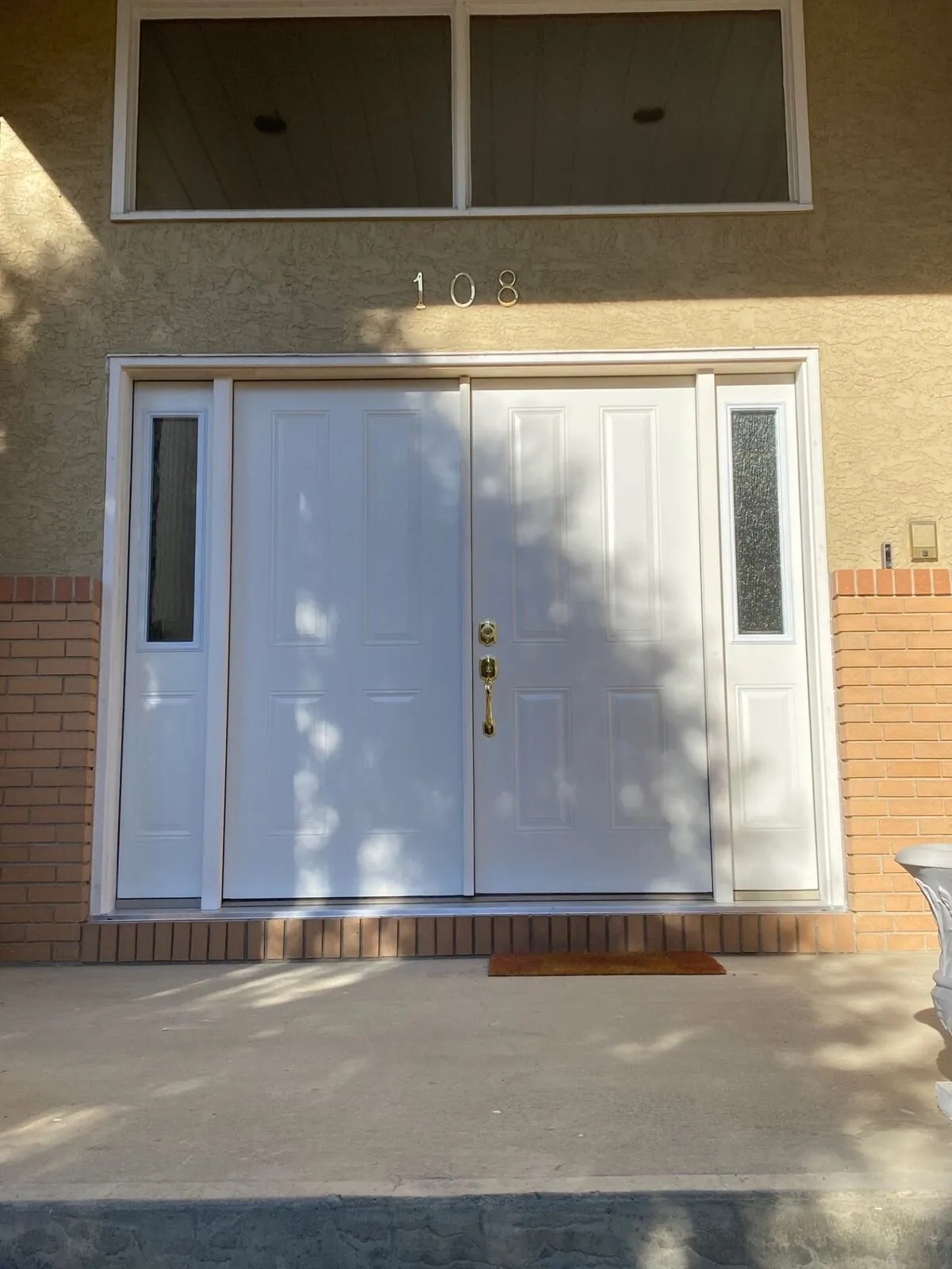 Double entry doors on a stone-front home