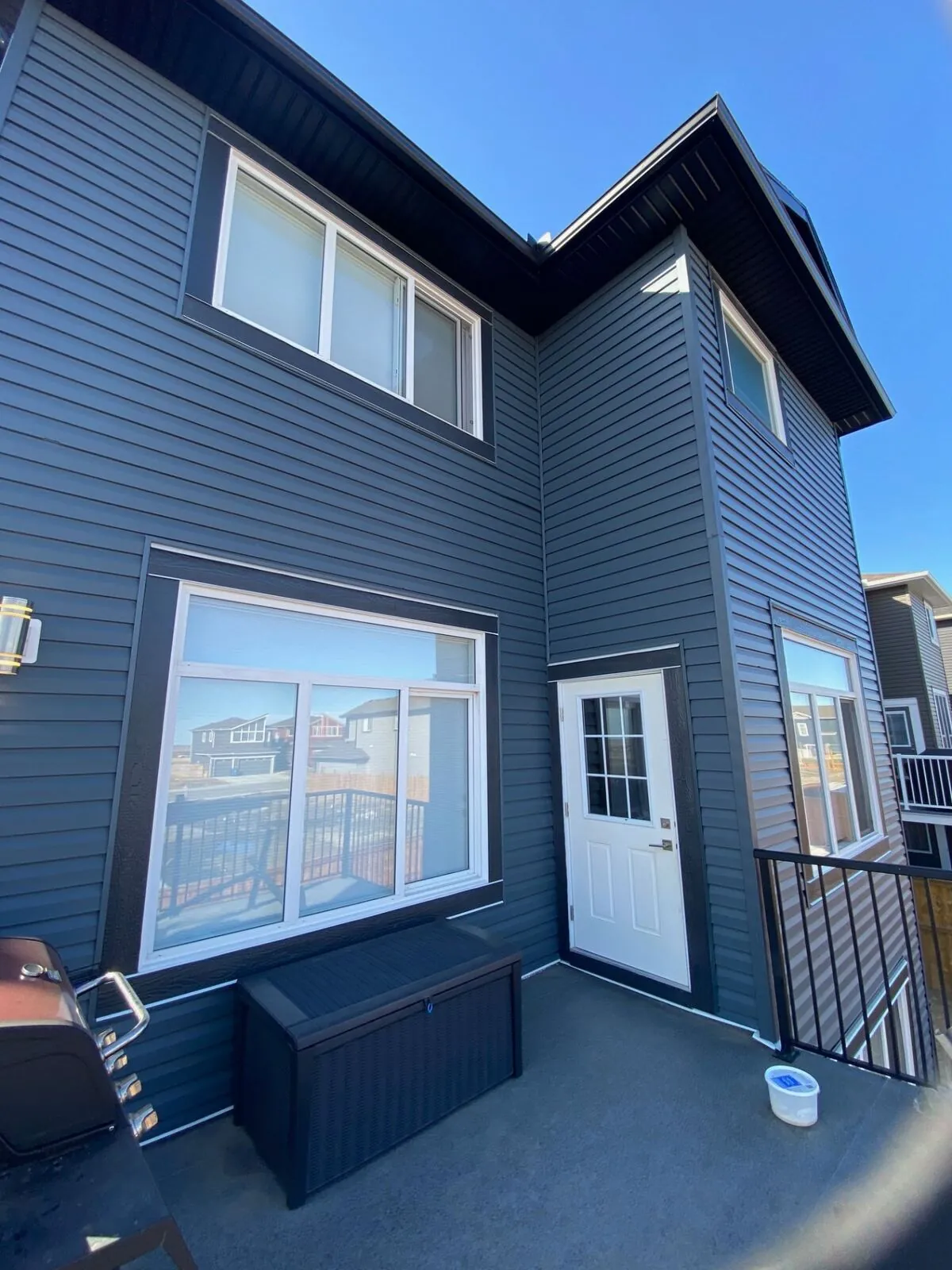 Navy vinyl siding with white trim