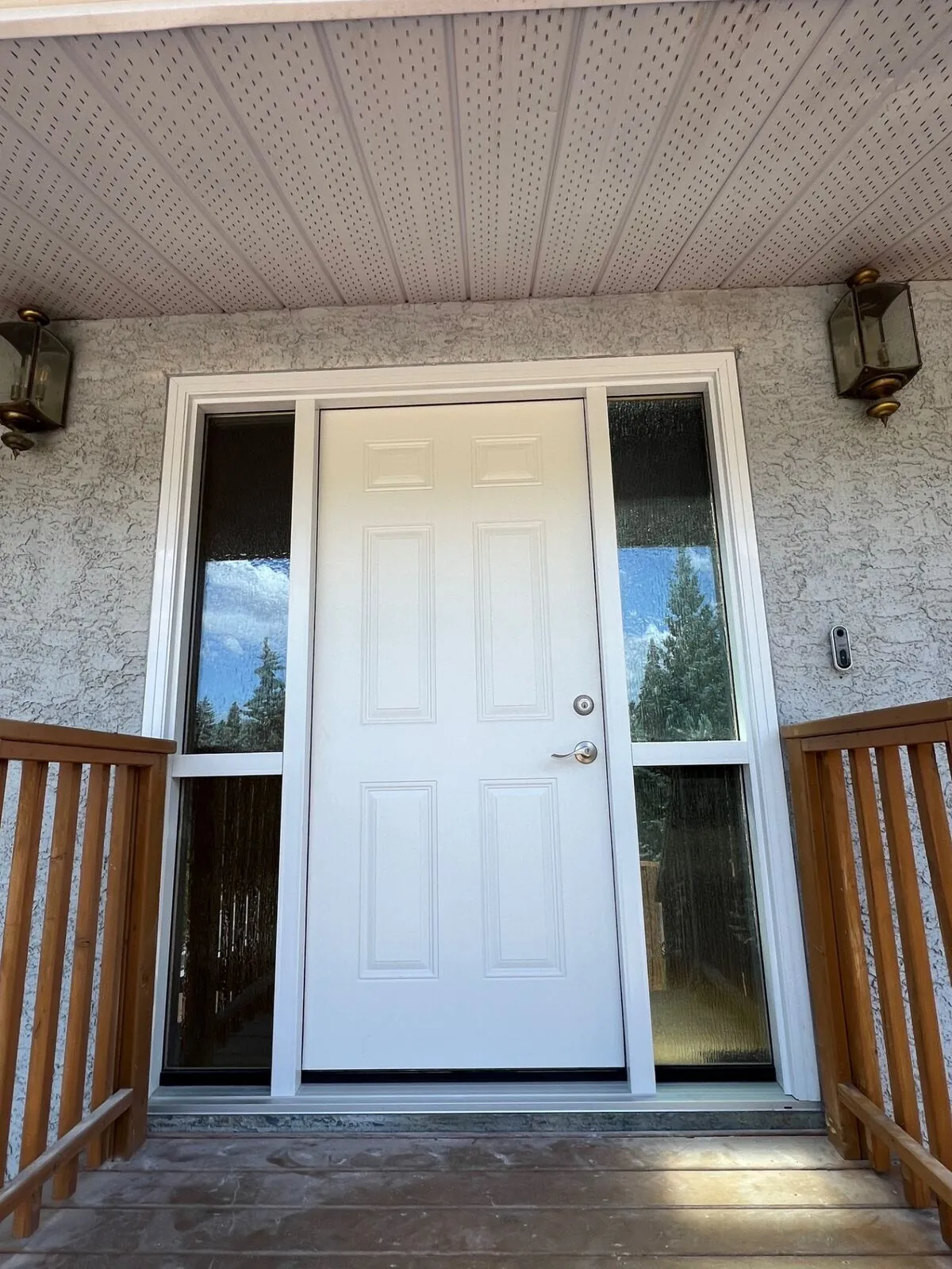 Classic entry door flanked by sidelites